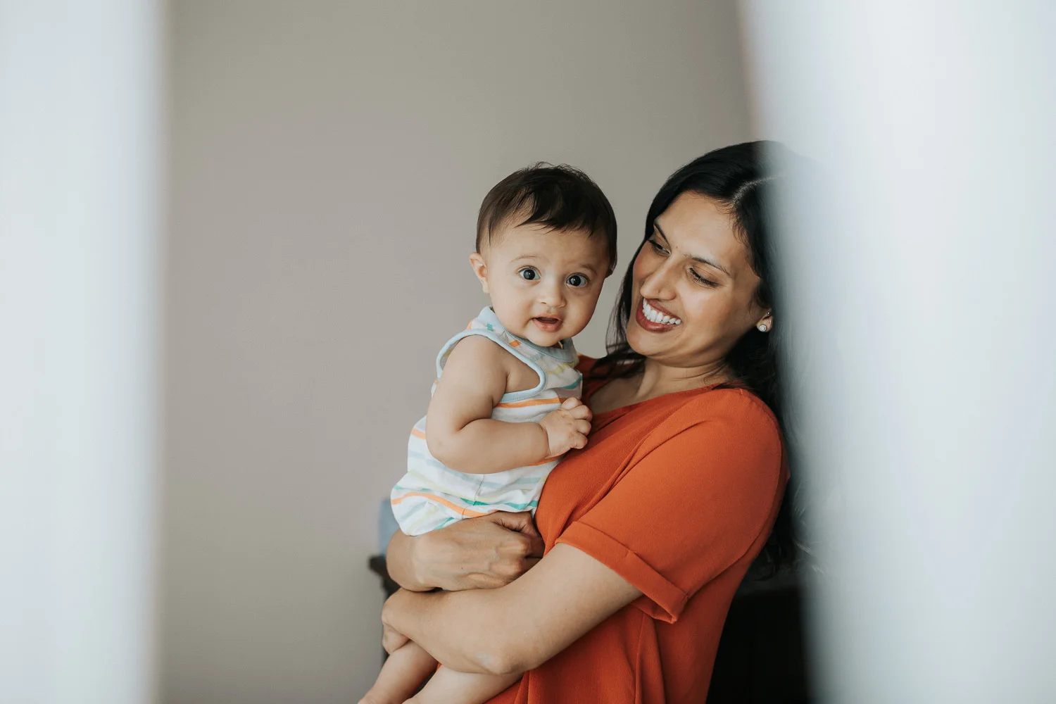 A smiling mother holding her baby